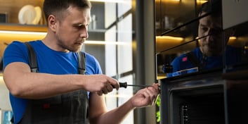 Field technician repairs a major appliance