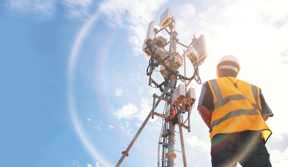 Field Service Worker looking at Telecom tower